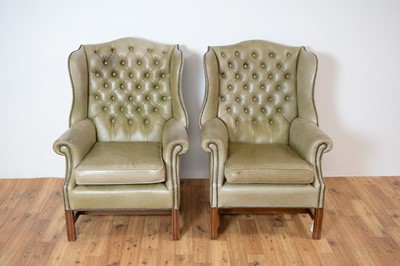 Lot 70 - A pair of 20th Century wingback armchairs upholstered in light green leatherette