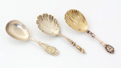 Lot 177 - Two Victorian silver caddy spoons and another with figural terminal