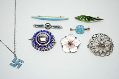 Lot 96 - A selection of silver and enamel brooches and a pendant.