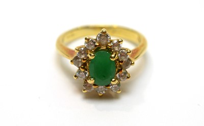 Lot 185 - An emerald and white stone cluster ring