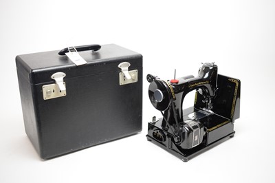 Lot 507 - A Singer 222K sewing machine, in carry case, with sewing accessories.