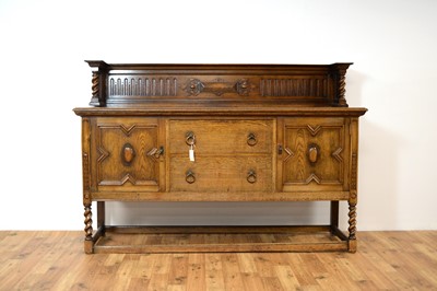 Lot 69 - A 20th Century Jacobean revival oak dining suite