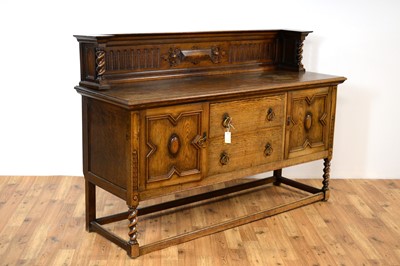 Lot 69 - A 20th Century Jacobean revival oak dining suite