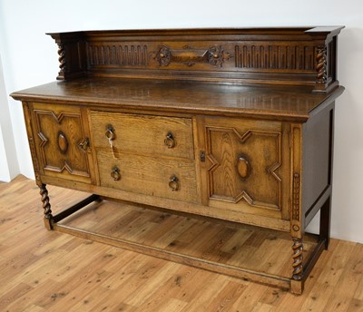 Lot 69 - A 20th Century Jacobean revival oak dining suite