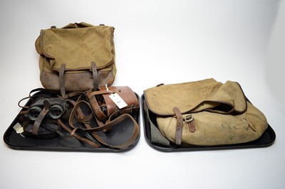 Lot 451 - Two pairs of binoculars; together two leather bound canvas bags.