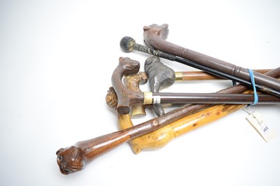 Lot 462 - A selection of 20th Century walking sticks, each with bulldog head handle, most carved