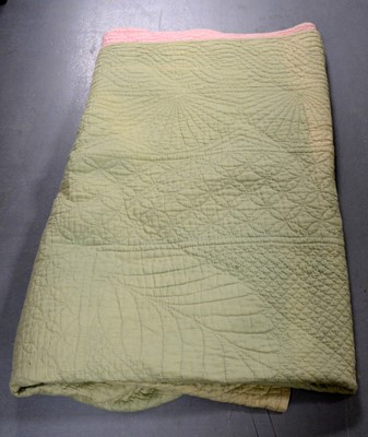 Lot 304 - A two-tone Durham quilt, in lime green and pink.