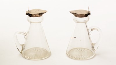 Lot 12 - A pair of George V silver-mounted clear glass whisky tots or chota pegs