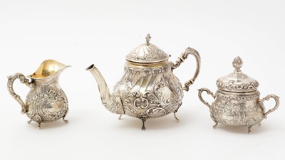 Lot 117 - A 20th Century German silver cream jug and covered sugar bowl; and a silver teapot