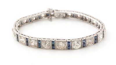 Lot 557 - A fine graduated diamond and sapphire bracelet