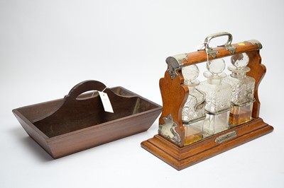 Lot 306 - A Victorian mahogany three bottle tantalus with silver plated mounts