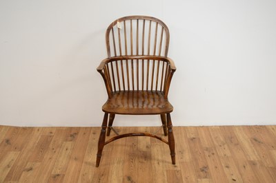 Lot 23 - A 19th Century yew and elm comb back Windsor chair
