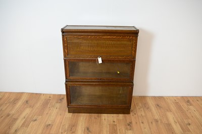 Lot 67 - Attributed to Globe Wernicke - an early 20th Century oak triple sectional bookcase