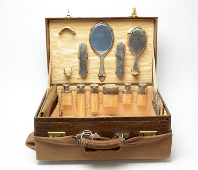 Lot 225 - An early 20th Century brass bound leather vanity case