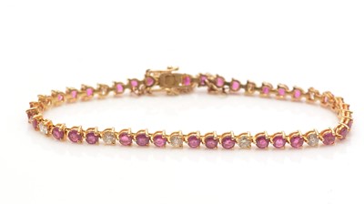 Lot 688 - A diamond and ruby line bracelet