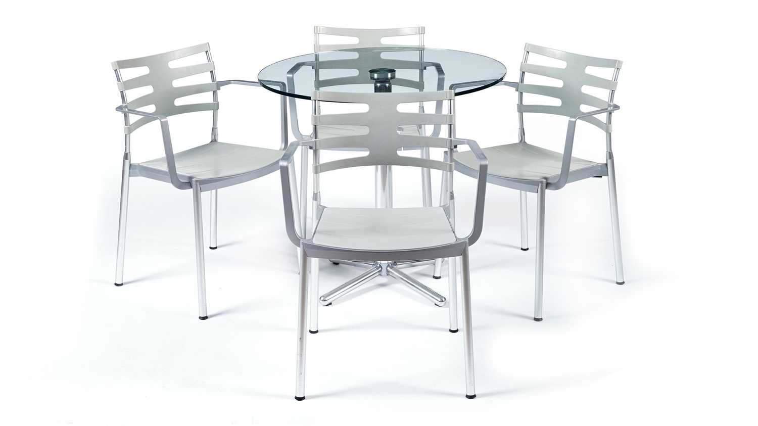 Lot 27 - A contemporary chrome and glass tilt action table / Fritz Hansen - Ice dining chair by Kaspar Salto