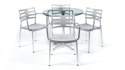 Lot 27 - A contemporary chrome and glass tilt action table / Fritz Hansen - Ice dining chair by Kaspar Salto