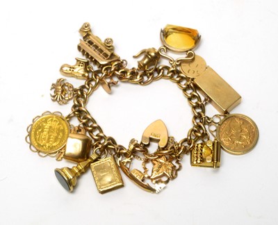 Lot 83 - A 15ct yellow charm bracelet with two half sovereign charms and others
