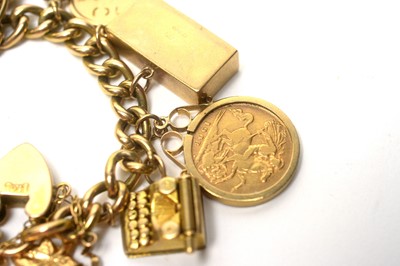 Lot 83 - A 15ct yellow charm bracelet with two half sovereign charms and others