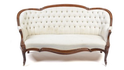 Lot 1443 - A Victorian carved walnut button-back show frame sofa