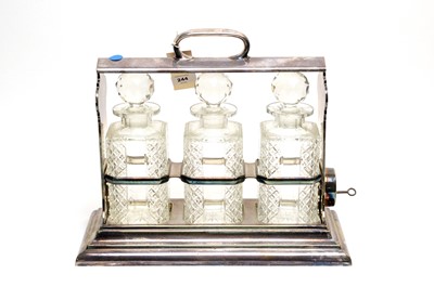 Lot 112 - A silver plated three bottle tantalus