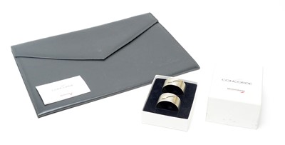 Lot 360 - A pair of silver Concorde napkin rings; and Concorde document case