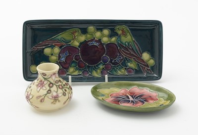 Lot 105 - Moorcroft pin tray, another. two small vases and an enamel box.