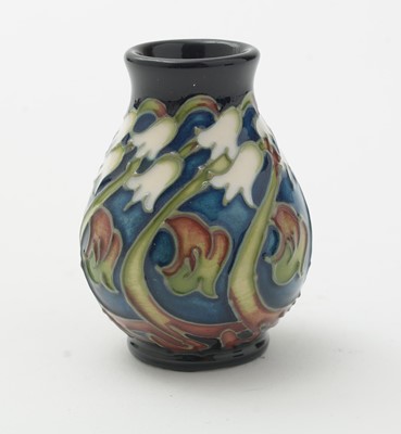 Lot 105 - Moorcroft pin tray, another. two small vases and an enamel box.