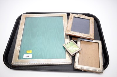 Lot 161 - Three silver photograph frames; together with a miniature white metal photograph frame.