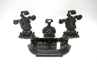 Lot 202 - Three cast iron door stops; and a cast iron boot scraper