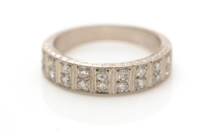Lot 659 - A diamond half-hoop eternity ring