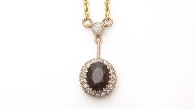 Lot 676 - A garnet and diamond cluster pendant necklace
