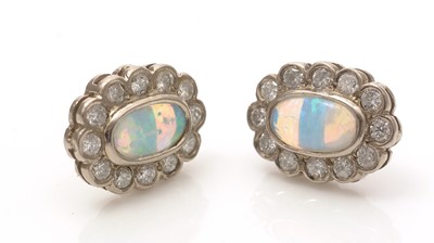 Lot 687 - A pair of opal and diamond cluster earrings