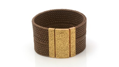 Lot 671 - An early Victorian plaited hair and 18ct yellow gold cuff bracelet
