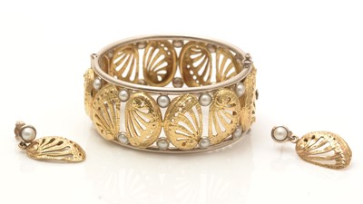 Lot 790 - Catherine Best: an 18ct white and yellow gold and half pearl bangle and matching earrings