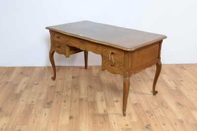 Lot 6 - A French-style oak serpentine fronted writing desk