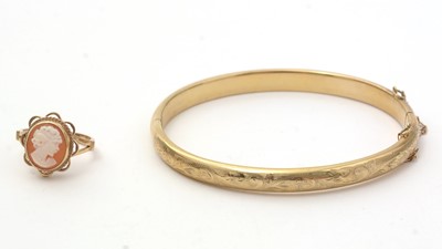 Lot 183 - A 9ct yellow gold bangle; and a cameo dress ring