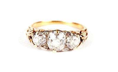 Lot 1129 - A Victorian three stone old-cut diamond ring