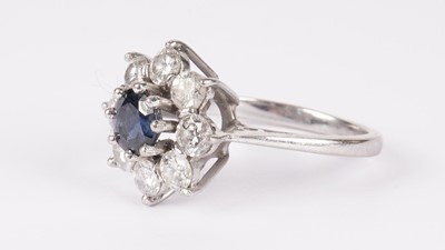 Lot 1130 - A sapphire and diamond cluster ring
