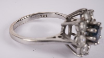 Lot 1130 - A sapphire and diamond cluster ring