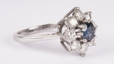 Lot 1130 - A sapphire and diamond cluster ring