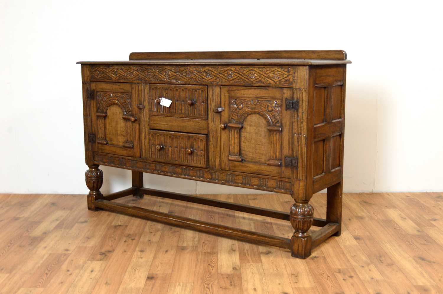 Lot 18 - Siesta by N.H Chapman of Newcastle upon Tyne: A Jacobean Revival oak sideboard