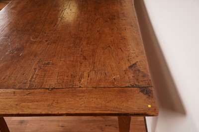 Lot 17 - A rustic French fruitwood refectory dining table