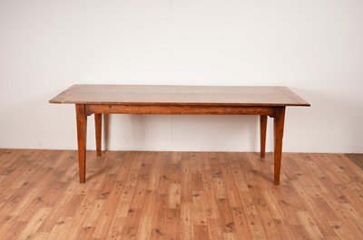 Lot 17 - A rustic French fruitwood refectory dining table