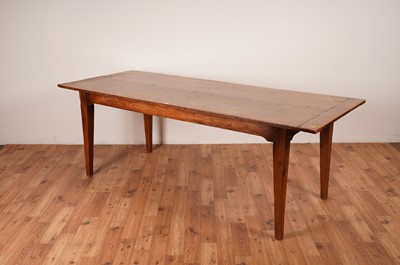 Lot 17 - A rustic French fruitwood refectory dining table