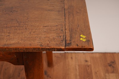 Lot 17 - A rustic French fruitwood refectory dining table