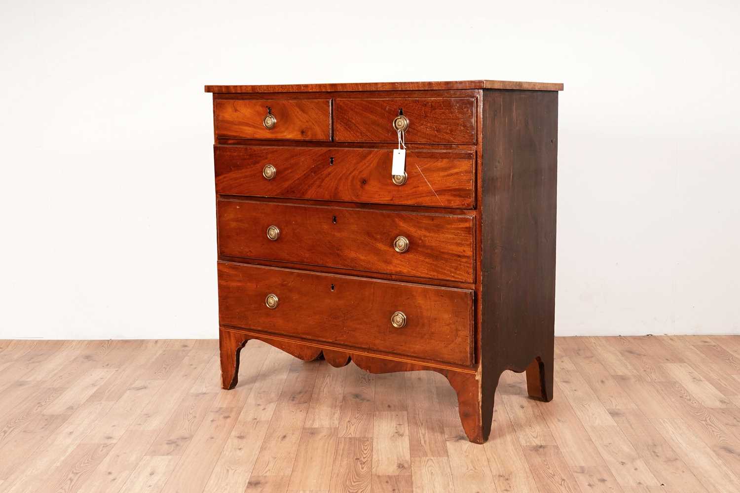 Lot 6 - A Georgian line inlaid mahogany chest of drawers