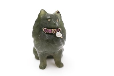 Lot 473 - A serpentine carved dog pattern pendant