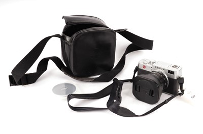 Lot 147 - A Leica camera and lens with a case