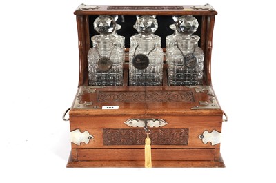 Lot 103 - A 20th Century oak three bottle tantalus